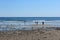 Several people walking along the rocky shoreline of Short Sands Beach,York, Maine, 2018