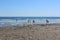 Several people walking along the rocky shoreline of Short Sands Beach,York, Maine, 2018