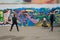 Several photographers take pictures of a young girl on a background of a wall with graffiti. Cheboksary. Russia