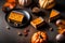 Several pieces of pumpkin cake with nuts on black table, a traditional autumn dish for thanksgiving day and halloween
