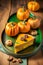 Several pieces of pumpkin cake with nuts on green table, a traditional autumn dish for thanksgiving day and halloween