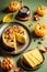 Several pieces of pumpkin cake with nuts on green table, a traditional autumn dish for thanksgiving day and halloween