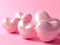 several pink heart shaped objects on pink background