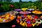 Several plates on a black table with many colorful flowers, Flower mandala