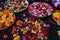 Several plates on a black table with many colorful flowers, Flower mandala