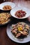 Several plates of pasta with different kinds of sauce over wooden background, top view.