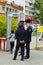 Several police officers works in control through the frame of a metal detector on a holiday in the city.