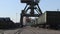 Several port cranes unloading wagons at intervals
