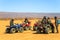 Several riders wait with their quad ATVs in the Sahara Desert