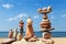 Several Rock zen pyramids of colorful pebbles on a beach on the background of the sea. Concept of balance, harmony and meditation