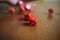 Several rolling red dice fall on a table