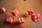 Several rolling red dice fall on a table