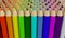Several rows of colored pencils isolated on white background