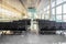 Several rows of modern black seats in the empty sunny waiting hall of the airport. Concept of loneliness, waiting, travelling,