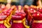 Several rows of red buddhist prayer candles