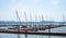 Several sailboats moored in a tranquil marina.