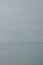 Several sailboats on the quiet lake water against a cloudy sky in Siofok, Balaton, Hungary