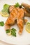 Several salmon steaks round plate spices