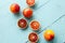 Several sanguine oranges on blue wooden background