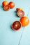 Several sanguine oranges on blue wooden background