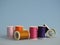 Several sewing thread spool, of varied colors.