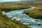 Several sheep walking along a stream, in the style of delicate Icelandic landscapes