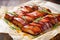 several slices of marinated pork belly on baking paper