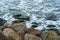 Several small and big white and gray stones or pebbles on the beach at the baltic sea