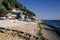 Several small fishing boats lie on the pebble beach of a colorful fishing village of Kavarna, Bulgaria, with a view of the