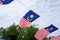 Several small Malaysian flags are tied together and installed horizontally.