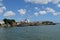 Several small white and blue fishing boats and colorful buildings from the river`s or ferry`s point of view. Location Brejo Gran