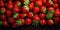 several strawberries close-up on a dark background. ripe berry, image for advertising.