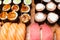 Several sushi and rolls on wooden board