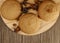 several sweet round cookies with cracks of light brown color lie on a wooden kitchen brown stand