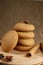 several sweet round cookies with light brown cracks lie on a wooden kitchen brown stand