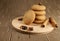 several sweet round cookies with light brown cracks lie on a wooden kitchen brown stand