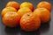 Several tangerines on a black surface