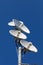 Several telecommunications antennas of a cellular network and wireless internet against a blue sky. Receiving and