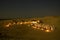 A several tents camp on the beach at night