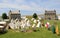 Several tents set up on lawn with stone buildings beyond, Fort Ontario, New York, 2016