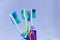 Several toothbrushes of different colors in a base and white background