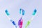 Several toothbrushes of different colors in a base and white background