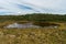 Several tourists Walking Around the Small Lagoon in the Paramo