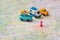 Several toy cars stand on a tourist map in a place marked with a pushpin. Trailer bus and jeep is in the tourist parking lot.