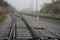 several train lines of electrical system in a foggy landscape.