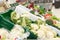 Several types of green cabbage in a sale bin at a supermarket. Side view. Wide assortment of healthy foods