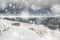 Several unidentifiedhikers in stormy winter landscape in Brecon Beacons in heavy snow storm