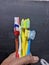 several used toothbrushes of various colors on a black background