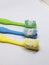 several used toothbrushes of various colors on a white background