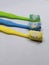 several used toothbrushes of various colors on a white background